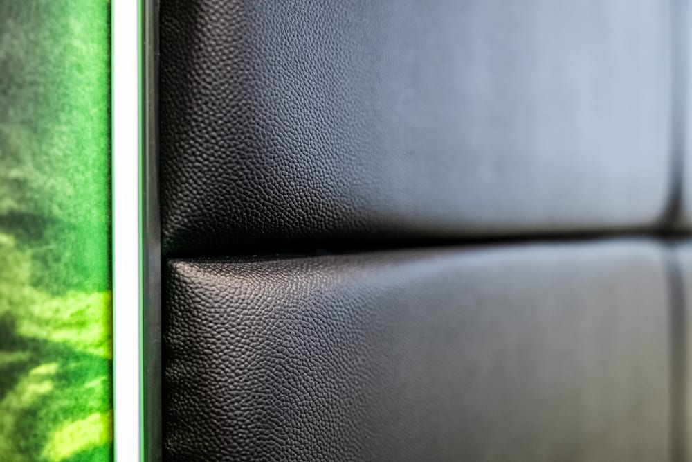 Close-up of the padded enclosure panels in a custom golf simulator bay